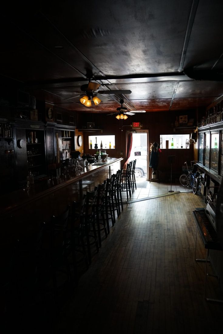 The long wooden bar at NEATFREAK!, lit from the front door